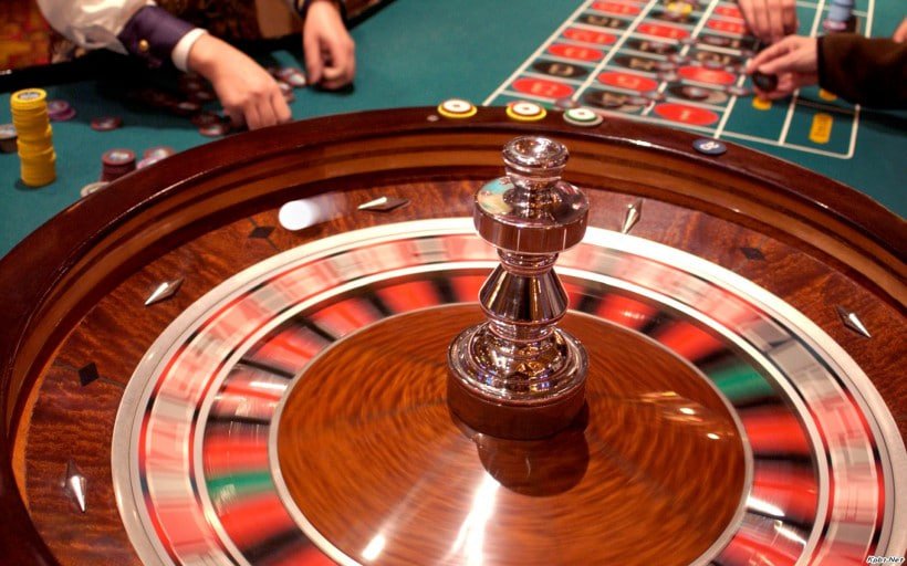 Multi-camera baccarat studio showing dealer, cards, and live statistics dashboard
